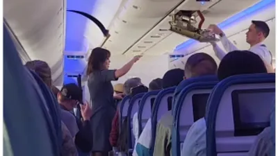 mid flight emergency  delta crew addresses loose ceiling panel