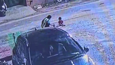 tragic  toddler playing with mother outside noida home run over by car