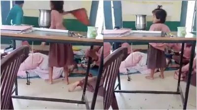 watch  uttar pradesh primary school teacher found sleeping as students fan her