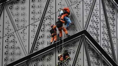 watch   spider man  arrested after attempting to scale 30 storey building without ropes